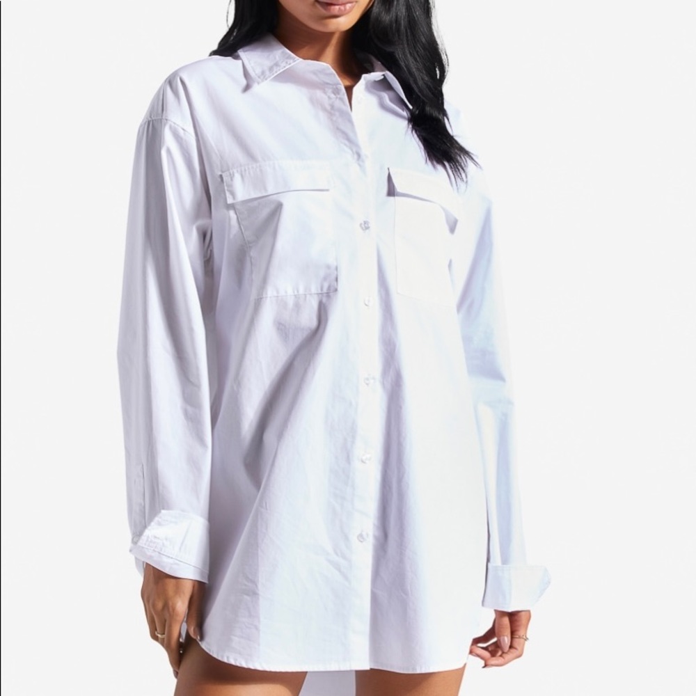 An oversized, button-down shirt dress with two front pockets.